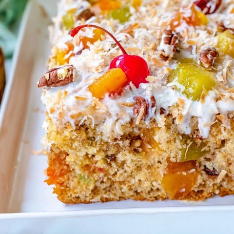 This fruit cocktail cake showcases a golden crumb, inviting you to enjoy its fruity flavors.