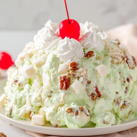 Delicious Watergate Salad, a creamy dessert with pineapple and whipped topping, perfect for any potluck.