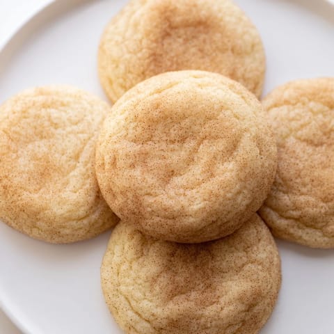 Close-up of perfectly rolled Snickerdoodles, coated in cinnamon sugar, before their delicious baking.