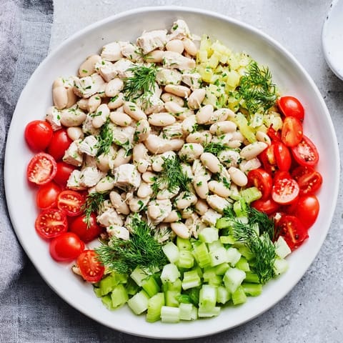 Tangy lemon vinaigrette coats shredded chicken and white beans in this refreshing Lemony White Bean Chicken Salad, garnished with crisp celery and bright fresh dill.