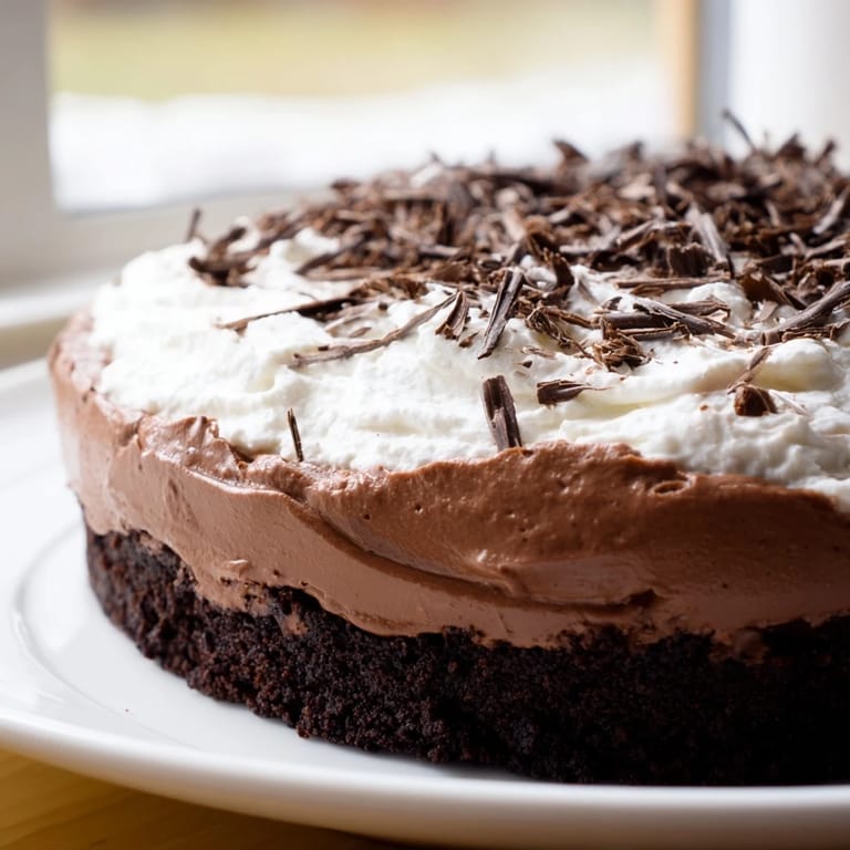 This tempting Mississippi Mud Pie features a fudgy brownie base, chocolate pudding, and fresh whipped cream.